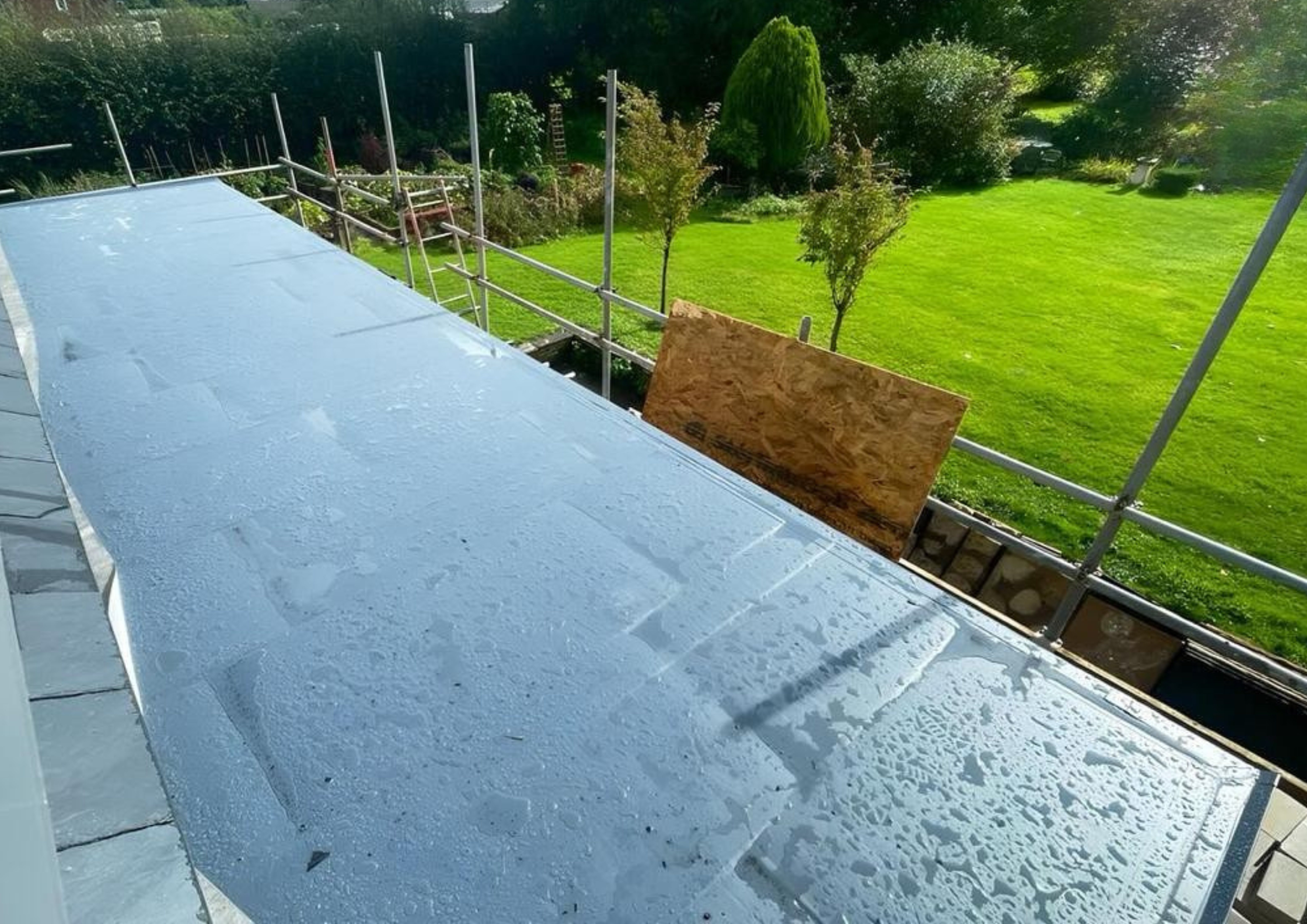 Flat roof insulation system being installed