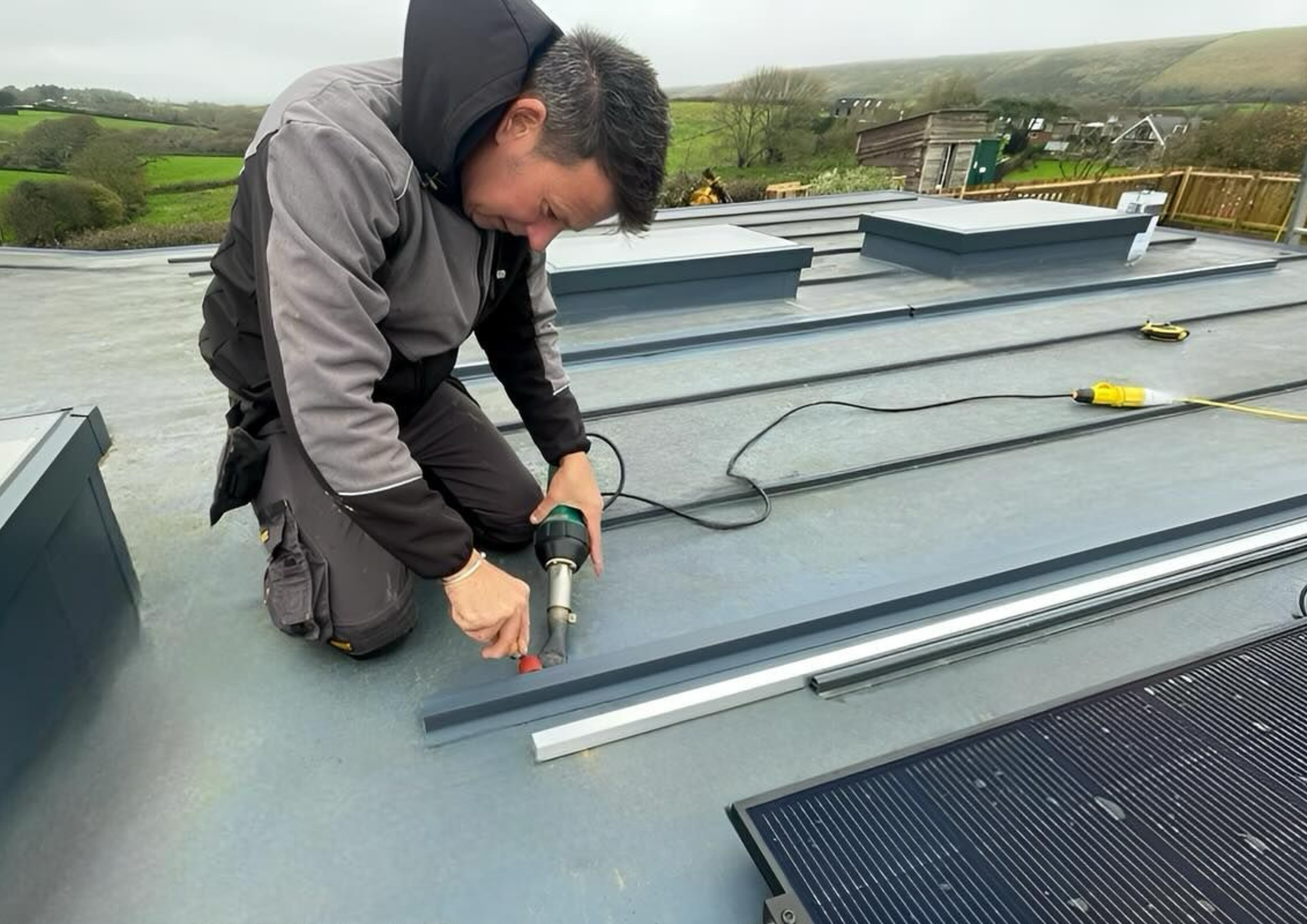 KJM roofer installing flat roof insulation